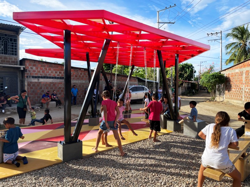recycled materials transform abandoned triangular lot in colombia into colorful urban space
