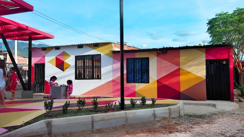 recycled materials transform abandoned triangular lot in colombia into colorful urban space