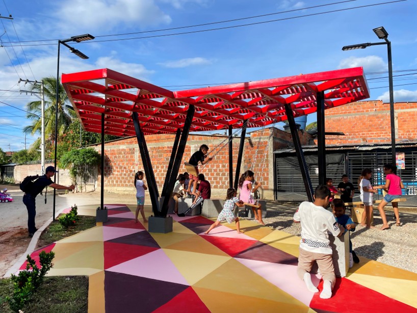 recycled materials transform abandoned triangular lot in colombia into colorful urban space