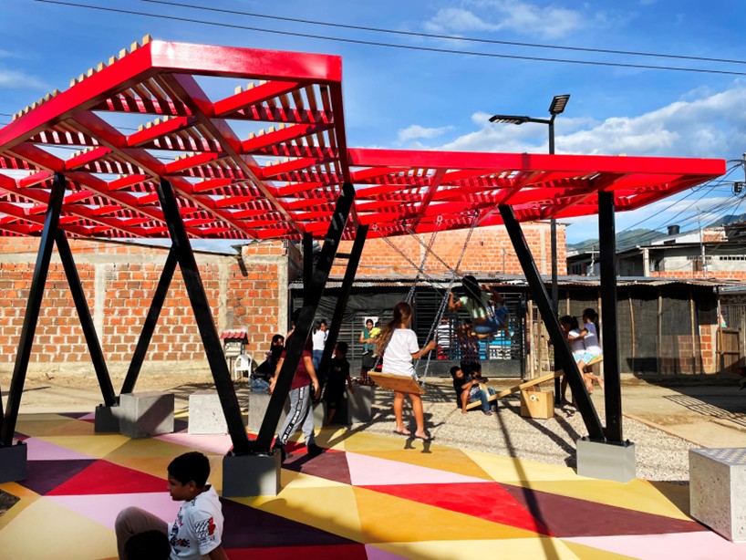 recycled materials transform abandoned triangular lot in colombia into colorful urban space