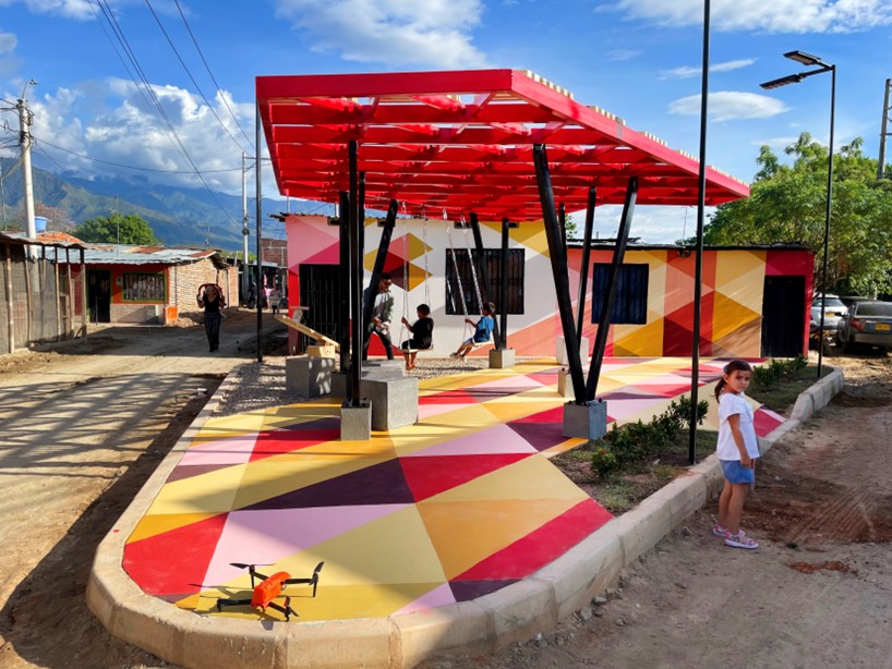 recycled materials transform abandoned triangular lot in colombia into colorful urban space