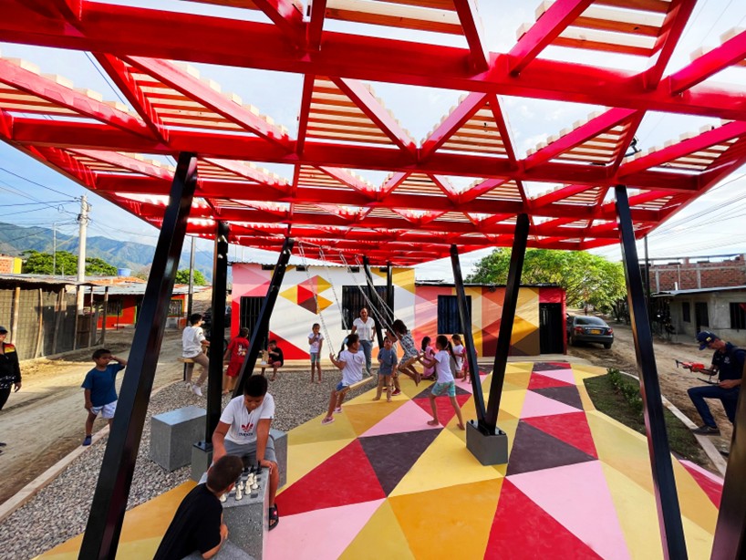 recycled materials transform abandoned triangular lot in colombia into colorful urban space