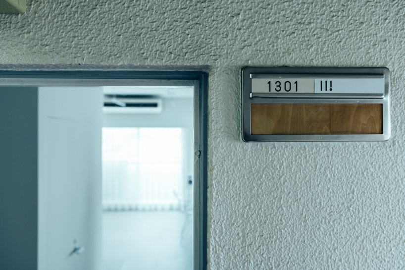 large floating mirror captures urban views within private salon by 2nf+ in tokyo