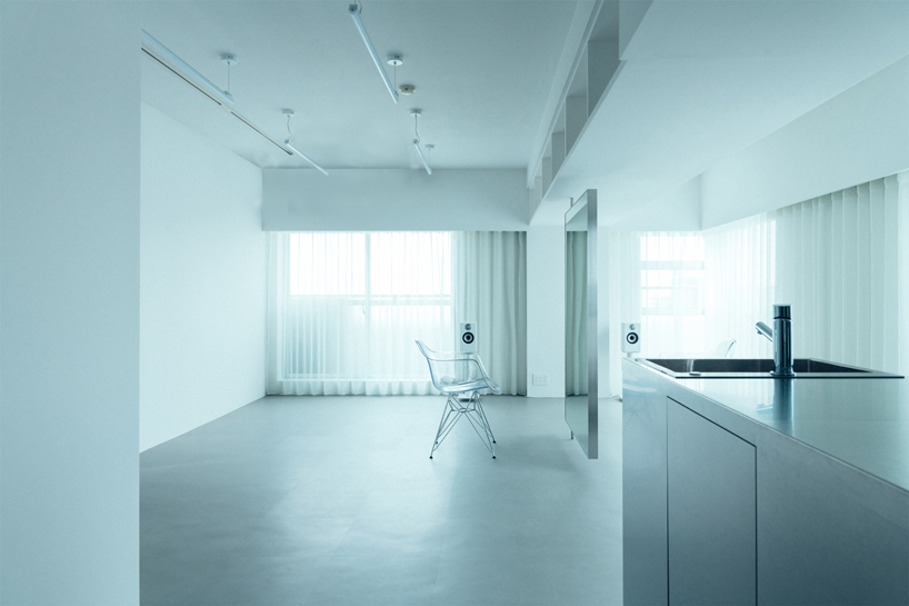 large floating mirror captures urban views within private salon by 2nf+ in tokyo