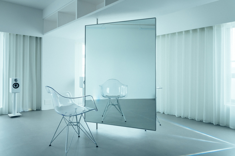 large floating mirror captures urban views within private salon by 2nf+ in tokyo
