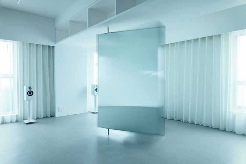 large floating mirror captures urban views within private salon by 2nf+ in tokyo