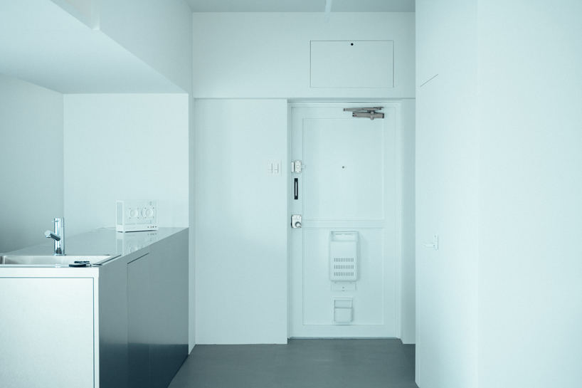 large floating mirror captures urban views within private salon by 2nf+ in tokyo