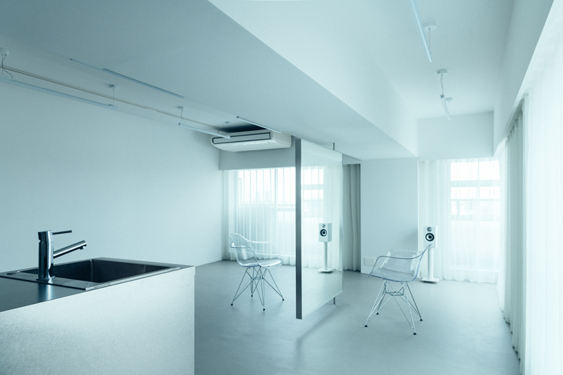 large floating mirror captures urban views within private salon by 2nf+ in tokyo