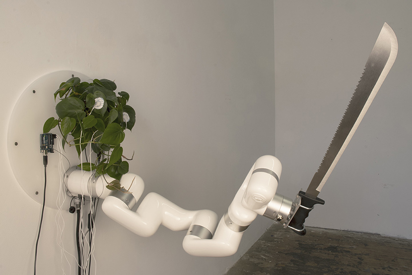 living plant controls a machete through an industrial robot arm