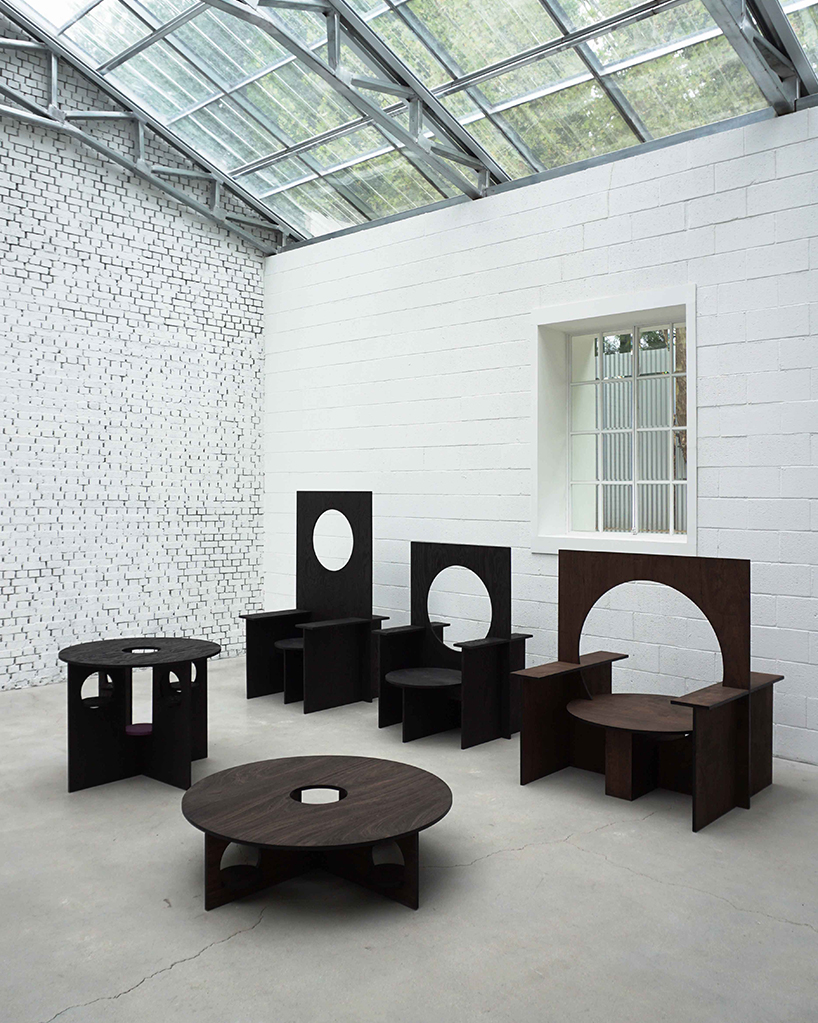 woocheol shin pierces dark wood furniture with circular openings for porthole series