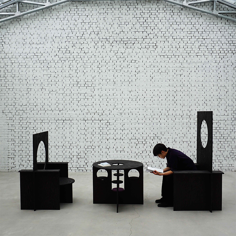 woocheol shin pierces dark wood furniture with circular openings for porthole series