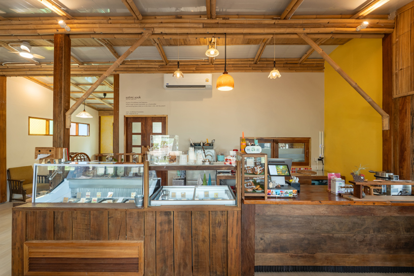 bamboo-clad ice cream shop tucks within coconut grove in thailand