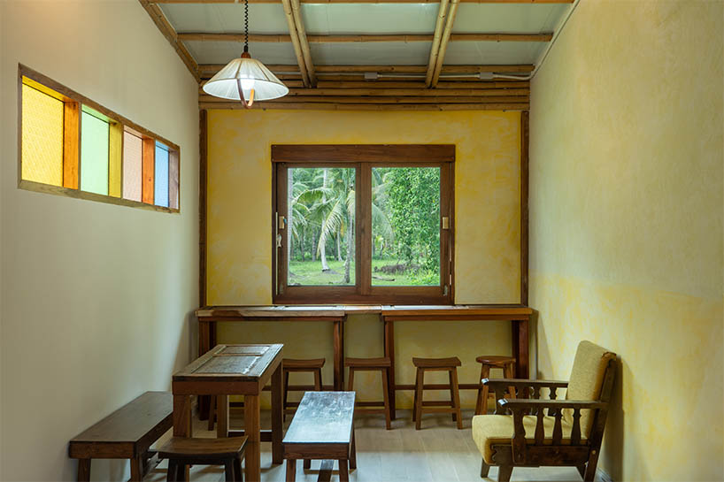 bamboo-clad ice cream shop tucks within coconut grove in thailand