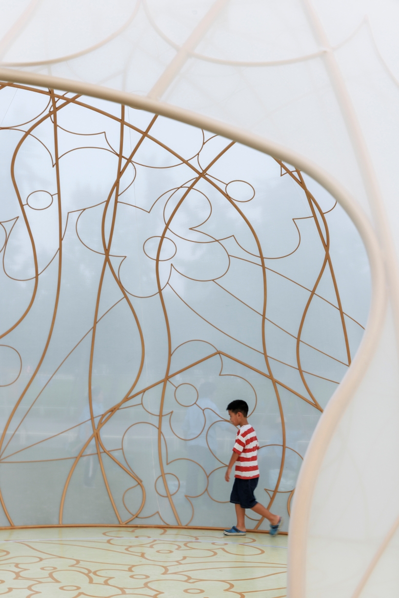 translucent illuminating dome bears bronze lattice of flower motifs in shanghai