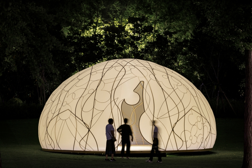 translucent illuminating dome bears bronze lattice of flower motifs in shanghai