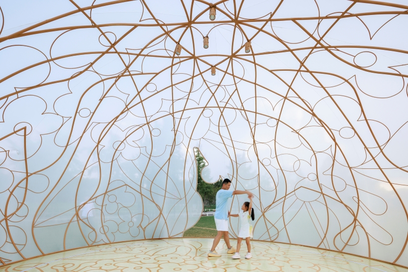 translucent illuminating dome bears bronze lattice of flower motifs in shanghai