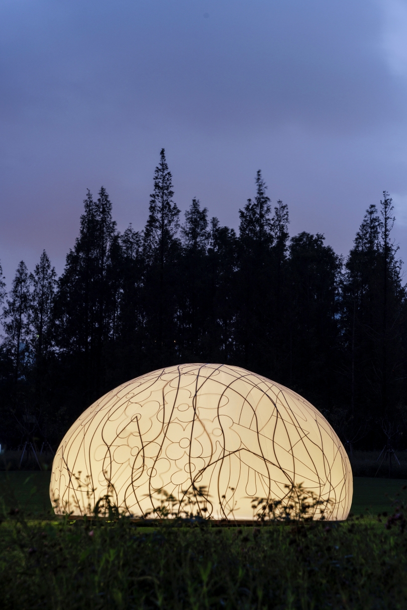translucent illuminating dome bears bronze lattice of flower motifs in shanghai