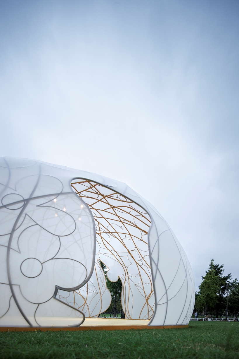 translucent illuminating dome bears bronze lattice of flower motifs in shanghai