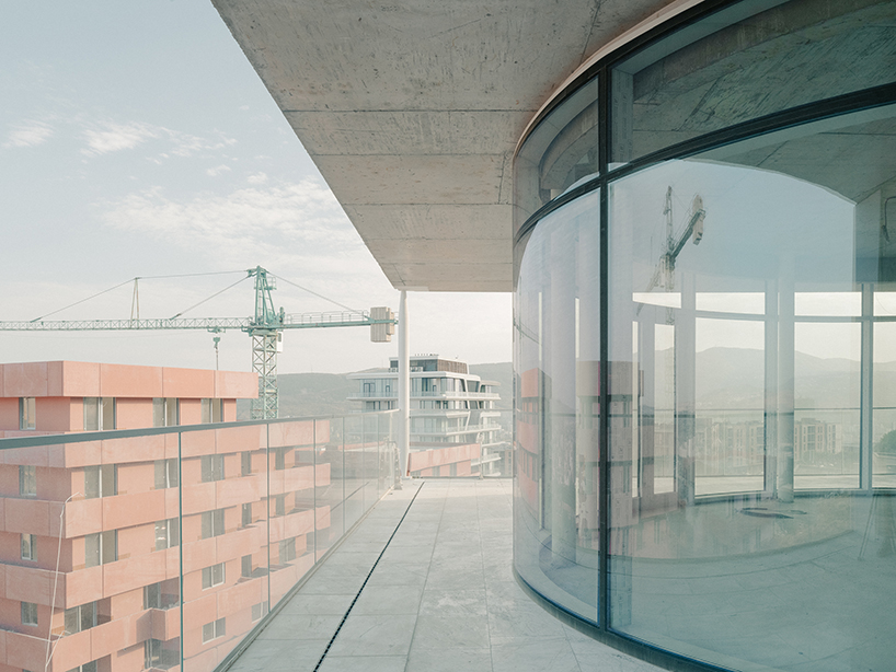 prismatic glass facade enfolds residential unit’s concrete modular framework in georgia