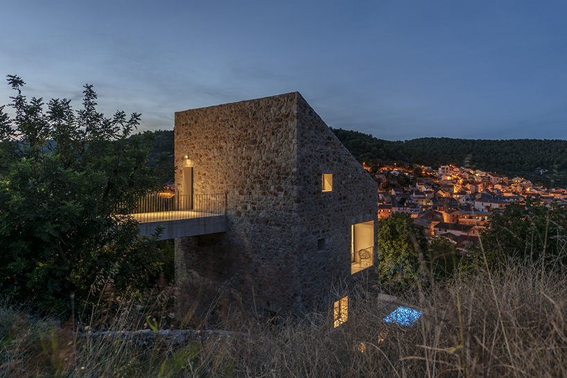 a stone house among hundred year old carob trees 11