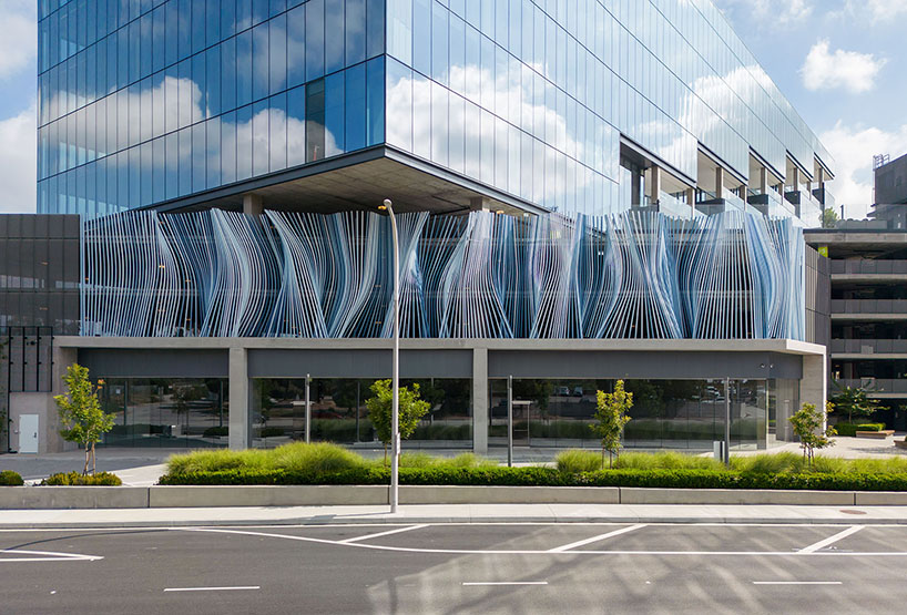 hundreds of aluminum tubes undulate shaping 'ensemble' installation by rob ley