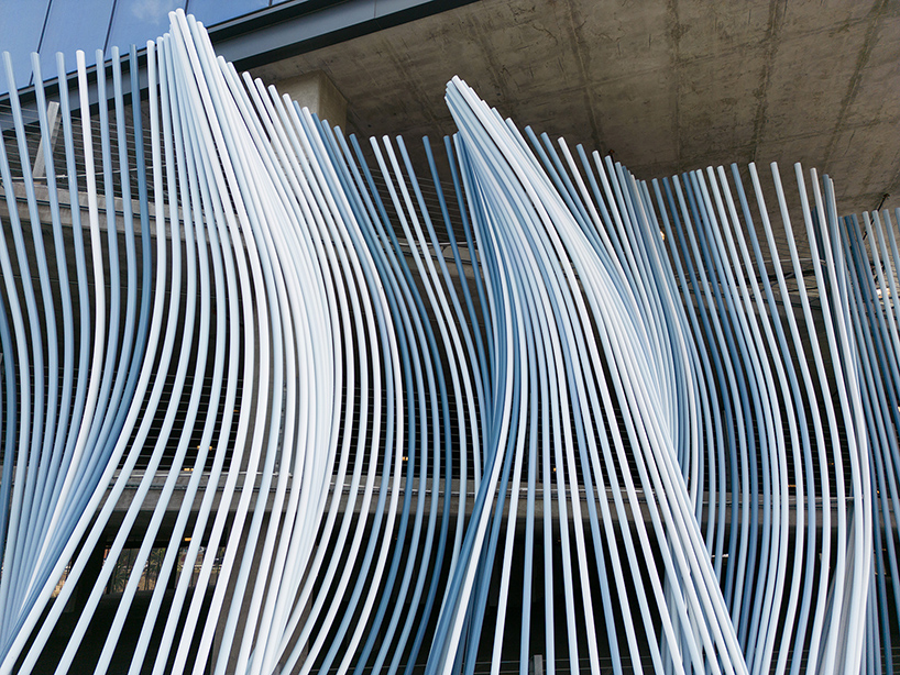 hundreds of aluminum tubes undulate shaping 'ensemble' installation by rob ley