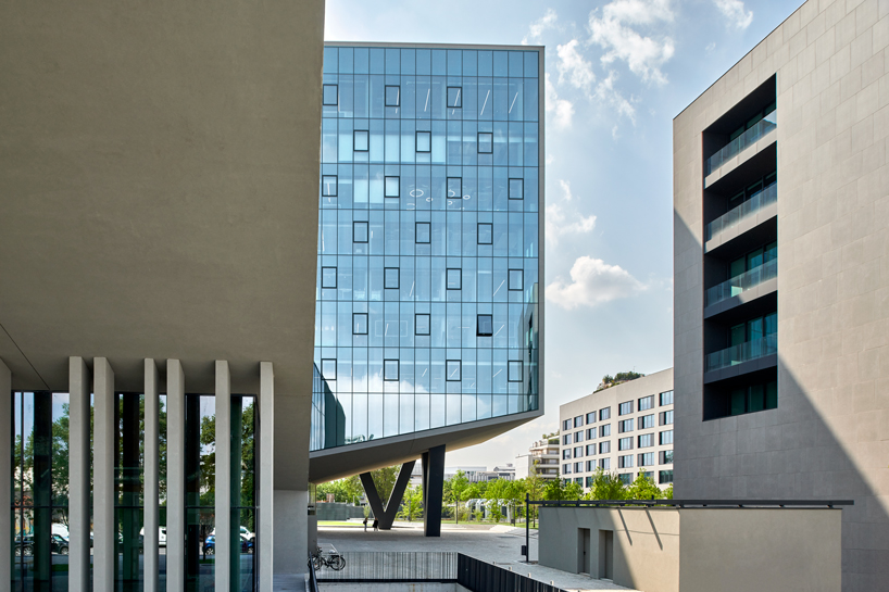 glass office building by ACPV towers over symbiosis business district in milan