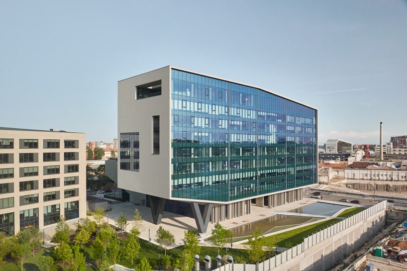 glass office building by ACPV towers over symbiosis business district in milan