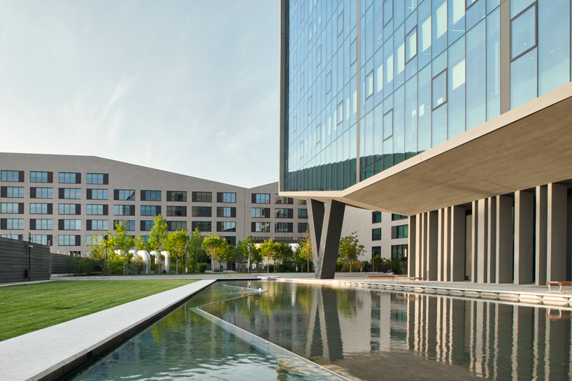 glass office building by ACPV towers over symbiosis business district in milan