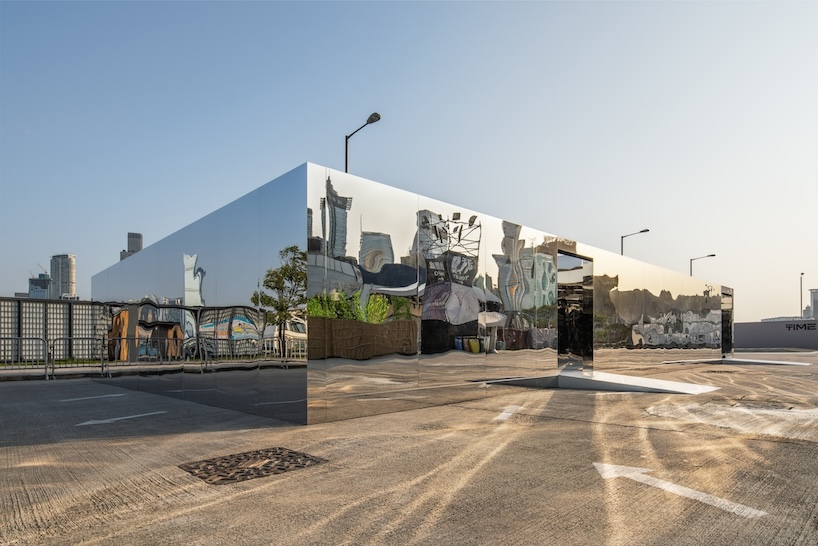 mirror maze's reflective pathways distort hong kong's harborfront