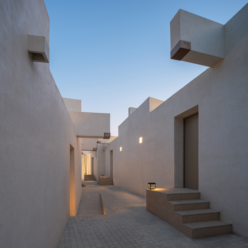 cluster of interwoven white courtyard houses reinterprets ancient kilns for resort in china