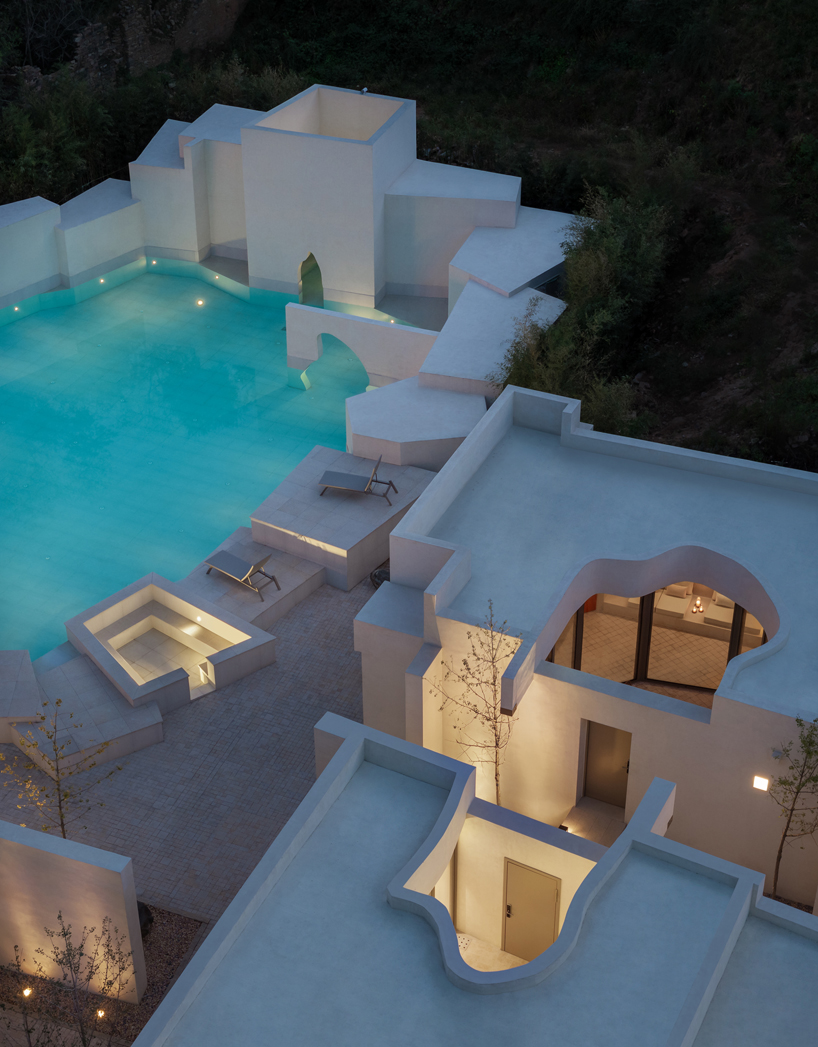 cluster of interwoven white courtyard houses reinterprets ancient kilns for resort in china