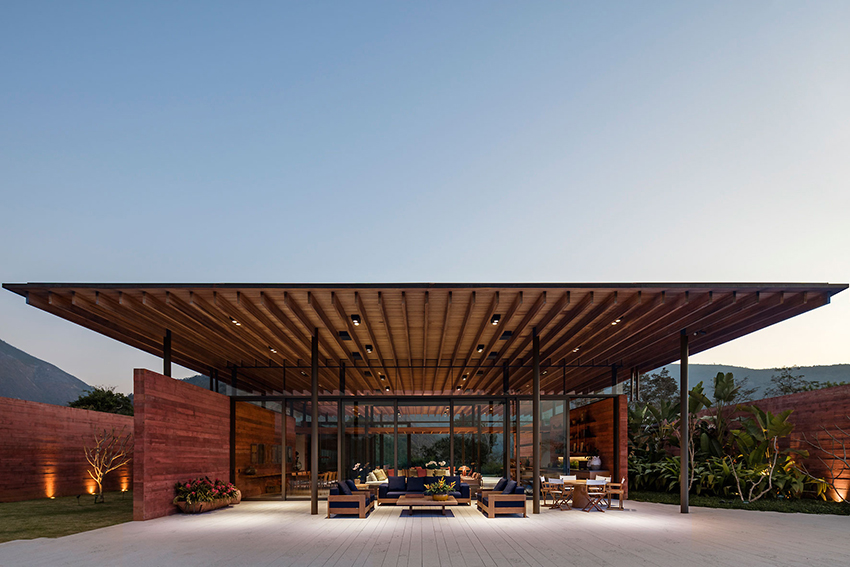 terracotta tinted walls adorn this hilltop weekend home in brazil