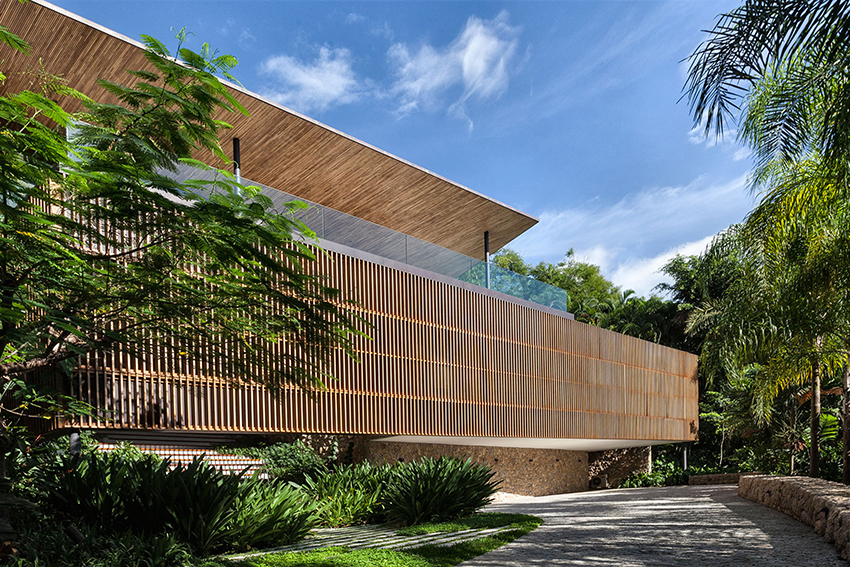 timber lattice façade with pivoting windows clads 'delta house' by bernardes arquitetura in brazil
