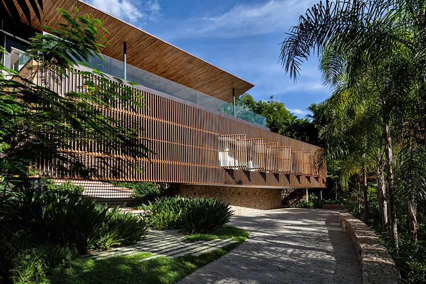timber lattice façade with pivoting windows clads 'delta house' by bernardes arquitetura in brazil