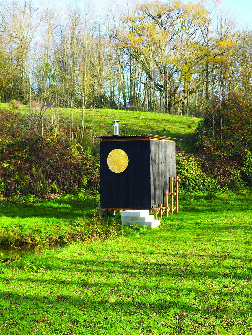 this charred timber sauna by atelier AJO emerges on the shore of french lake