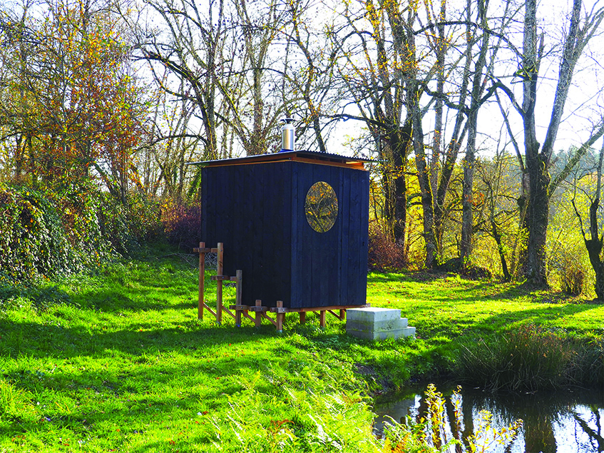 this charred timber sauna by atelier AJO emerges on the shore of french lake