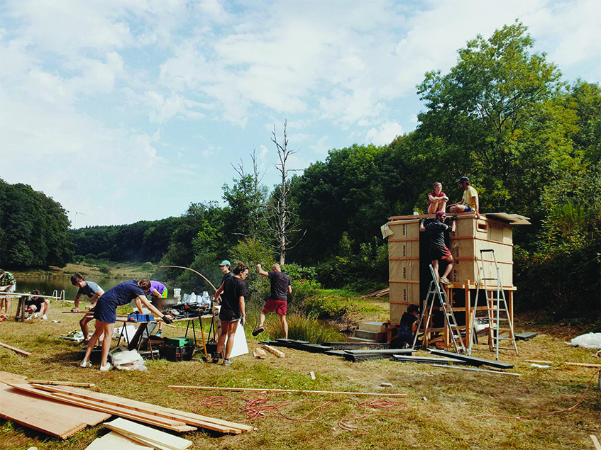 this charred timber sauna by atelier AJO emerges on the shore of french lake