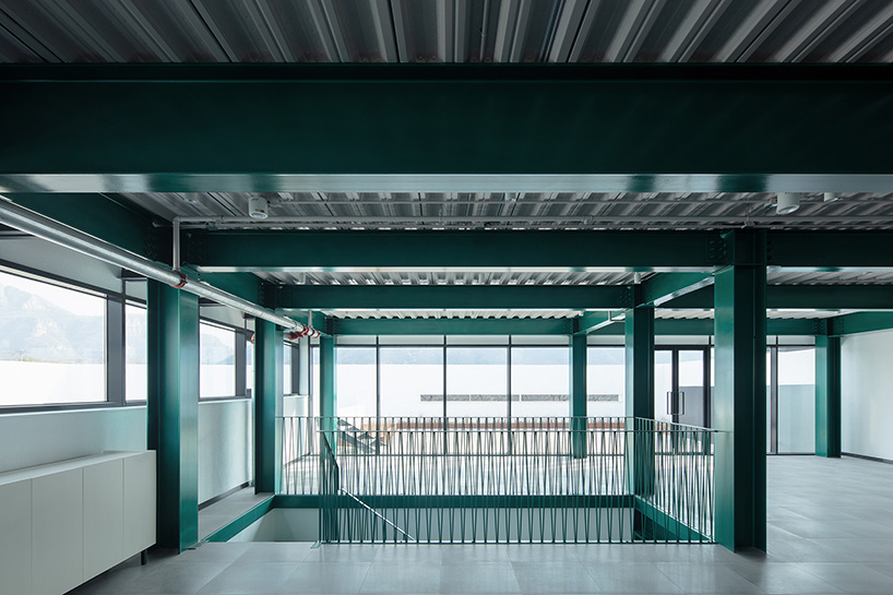 playful red platform encircles renovated youth activity center in china