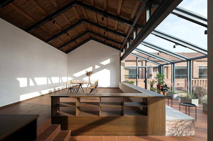 playful red platform encircles renovated youth activity center in china