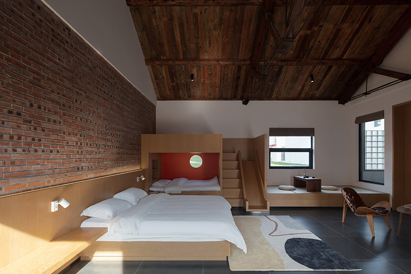 playful red platform encircles renovated youth activity center in china