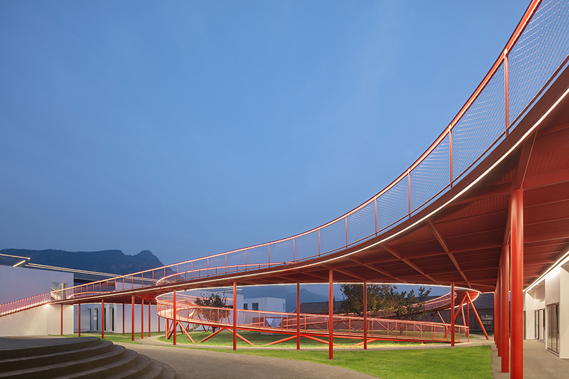 playful red platform encircles renovated youth activity center in china