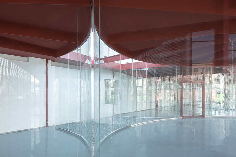 playful red platform encircles renovated youth activity center in china