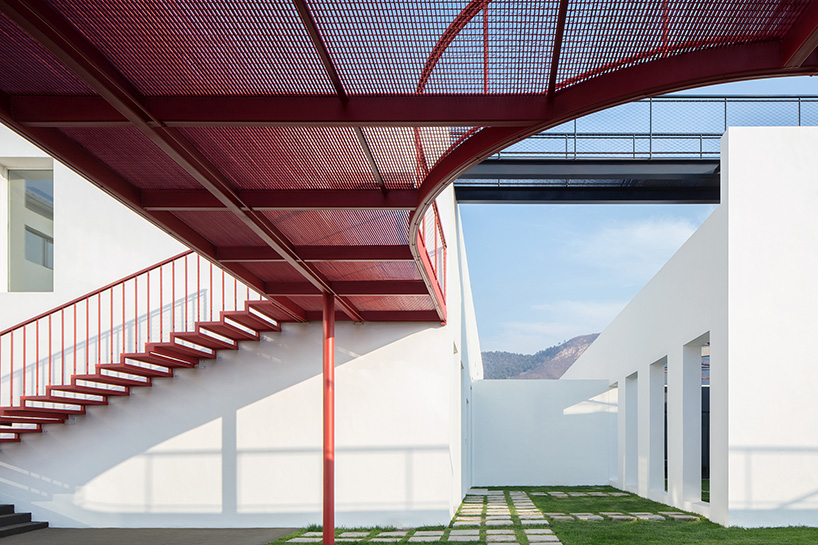 playful red platform encircles renovated youth activity center in china