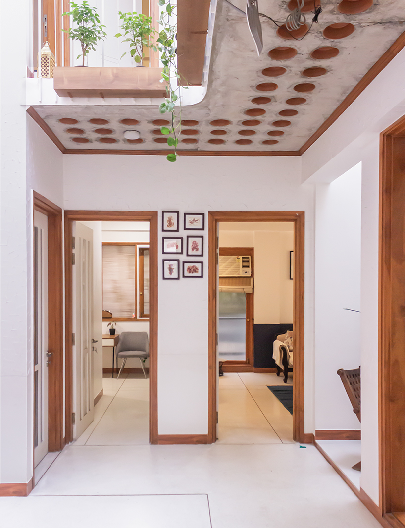 curved balconies clad in brick tiles outline a multi-generational indian home - 8