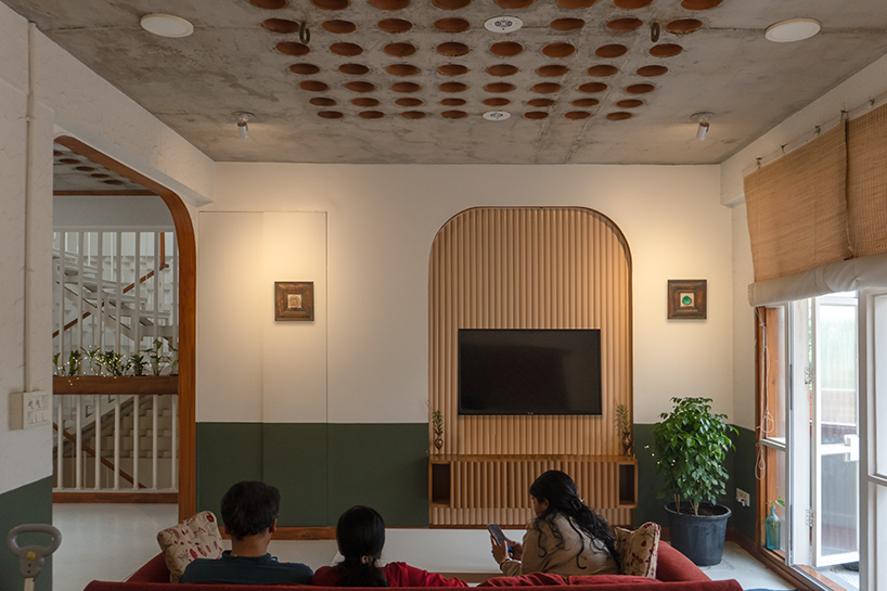 curved balconies clad in brick tiles outline a multi-generational indian home - 9