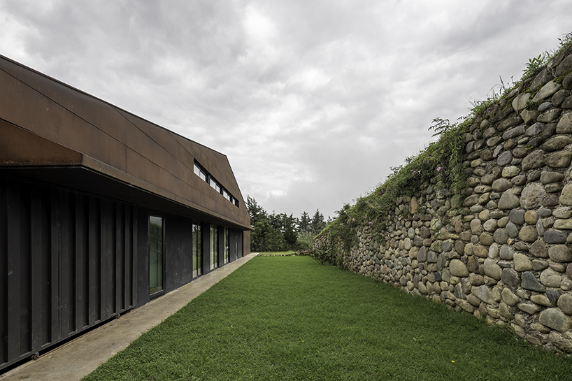 old warehouse is transformed into steel-clad modern country house in ecuador