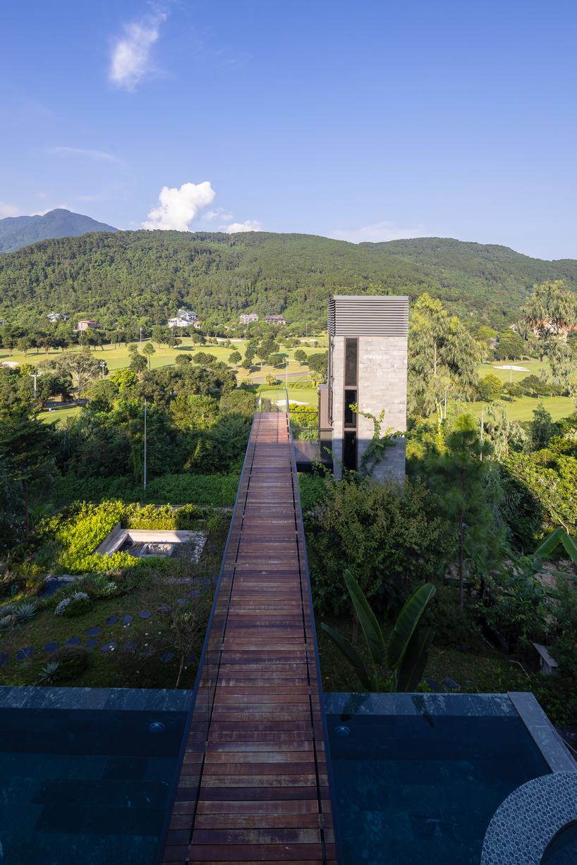steel frame supports stone-clad ajisai hill house's volumes unfolding in vietnam