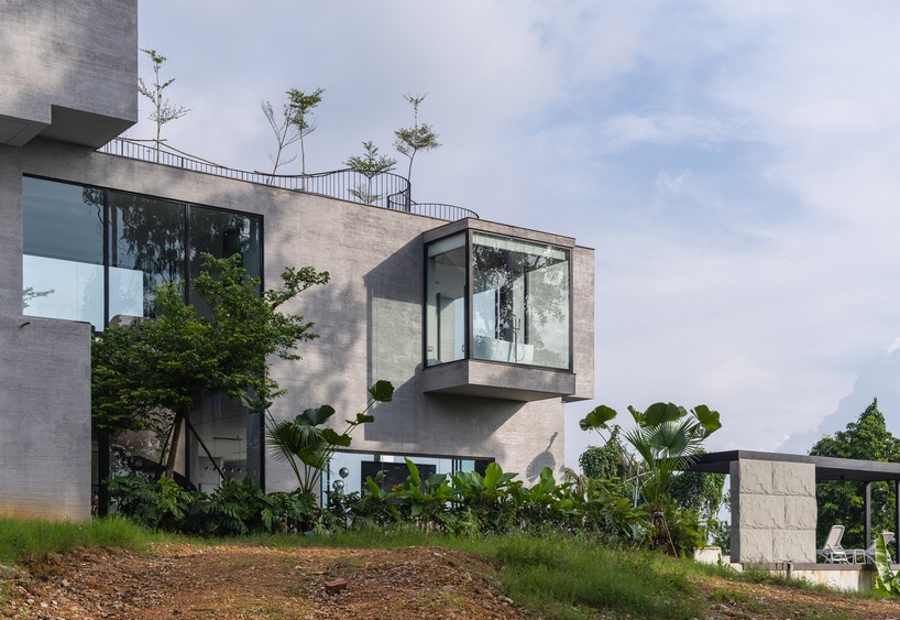 garden courtyards wind through stacked cubes of idee architects' vietnam hillside house