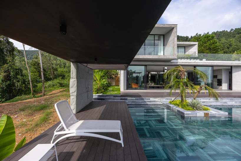 garden courtyards wind through stacked cubes of idee architects' vietnam hillside house